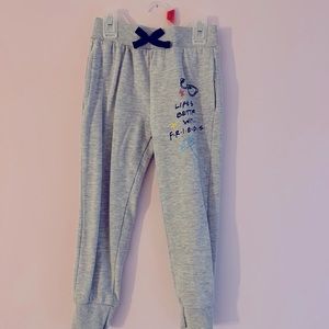 A gray pair of sweat pants with 2 side pockets.